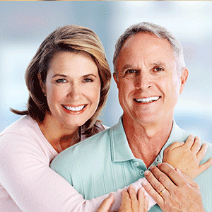 Elderly couple with beautiful teeth smiling