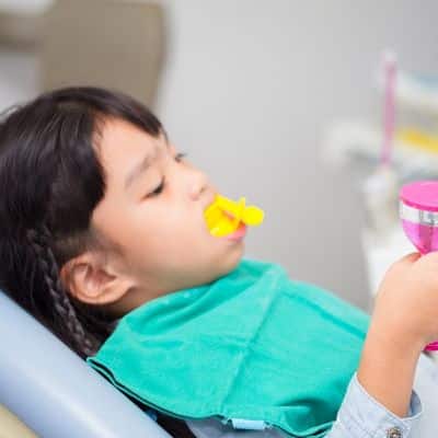 child receiving fluoride treatment JRFD