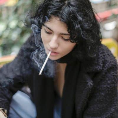 young woman smoking cigarette harmful effects of smoking