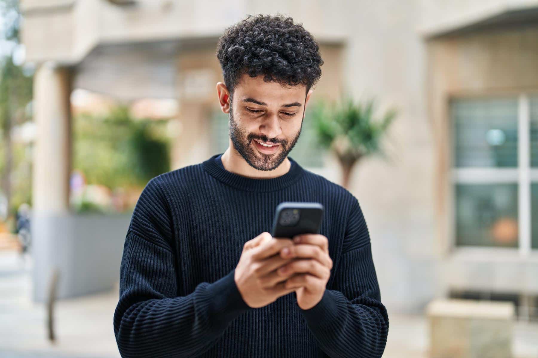 Man-looking-at-patient-information-on-cell-phone Patient information