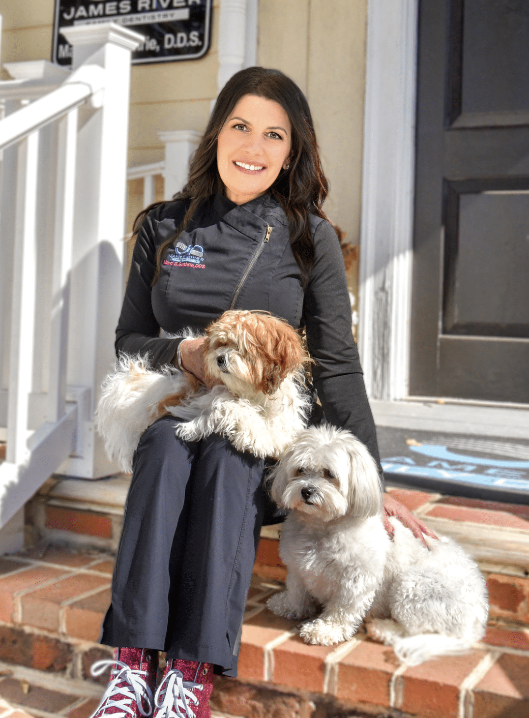 Dr-guthrie-therapy-dogs-porch Dr. Guthrie smiling with two dogs on front porch
