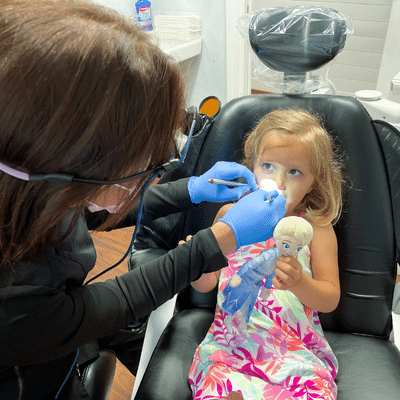 Celebrate children’s dental health month: best dental habits for children at home 4 Dr. Guthrie gently examines a young child’s teeth during a pediatric dental visit, reinforcing the best dental habits for children at home through positive early dental care.